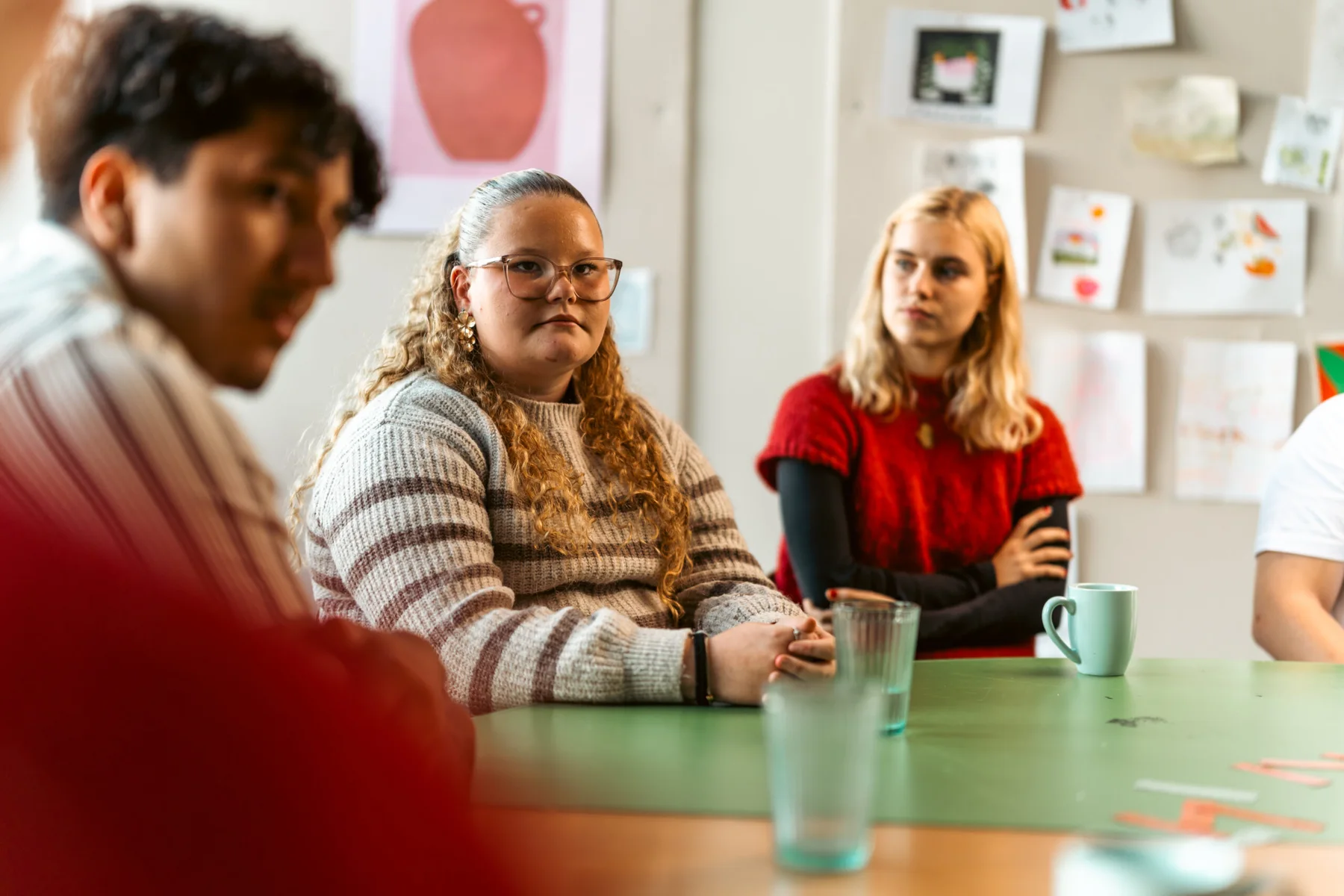 Unge mødes omkring et bord og lytter til hinanden i Ventilen